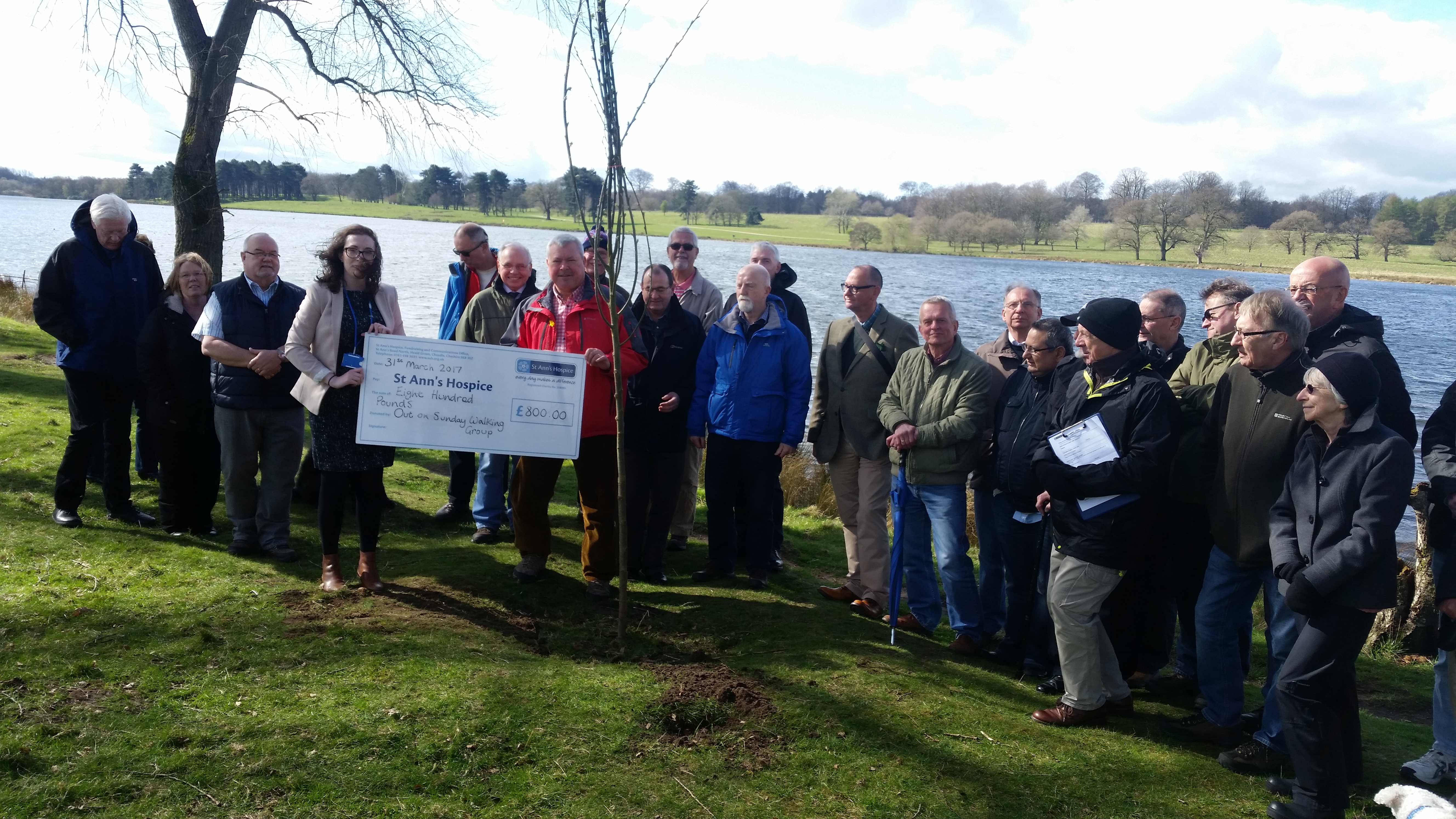 David Rhodes and fellow walkers with cheque
