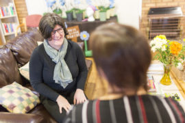 Two staff members talking on the sofa