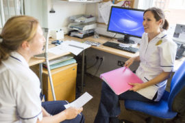 Two women talking in the office