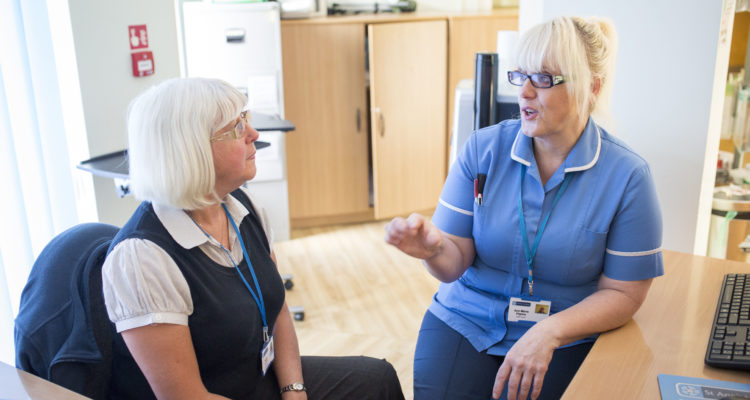 Two women talking in the office