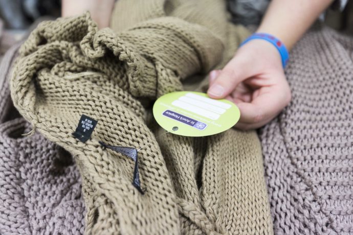 Jumper being sorted in Stockport charity shop