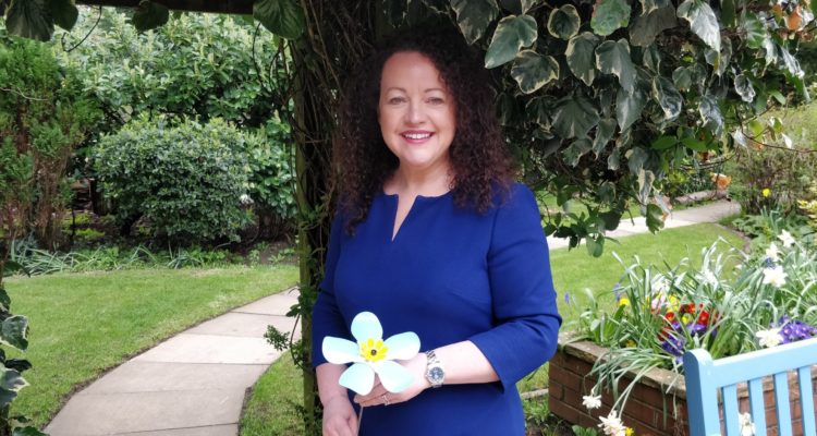 Rachel McMillan with forget-me-not flower