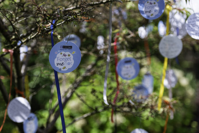 paper decorations hanging with ribbons on a tree