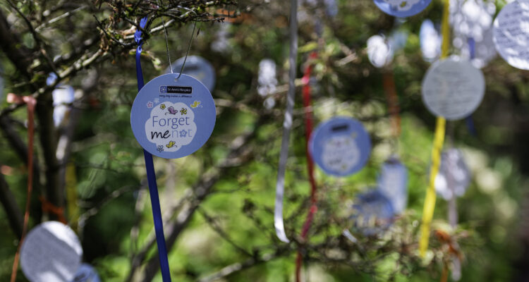 paper decorations hanging with ribbons on a tree